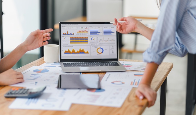 Two data analysts Working on data analysis dashboard for business strategy.