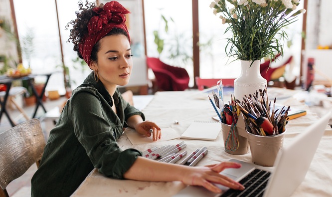 Young beautiful woman with dark curly hair sitting at the table